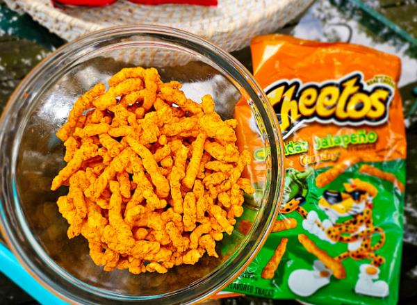 a bowl of cheetos cheddar jalapeno.